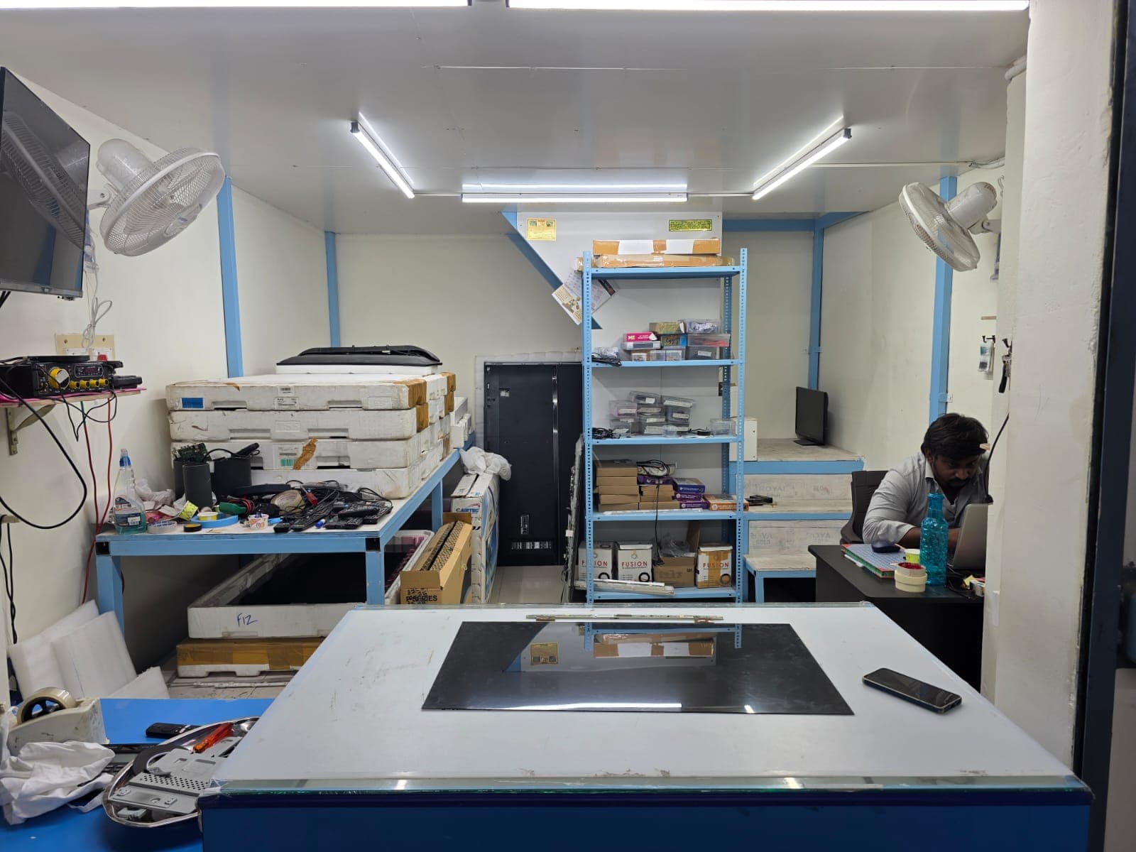 Technician inspecting TV components